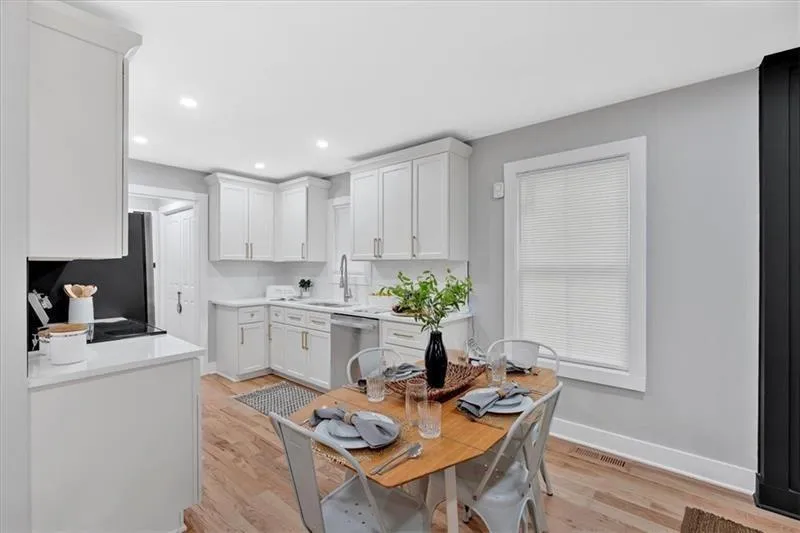 Kitchen with light wood-type flooring, white cabinets, recessed lighting, dishwasher, and electric range