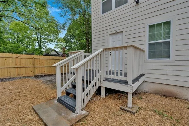 Wooden terrace featuring a fenced backyard