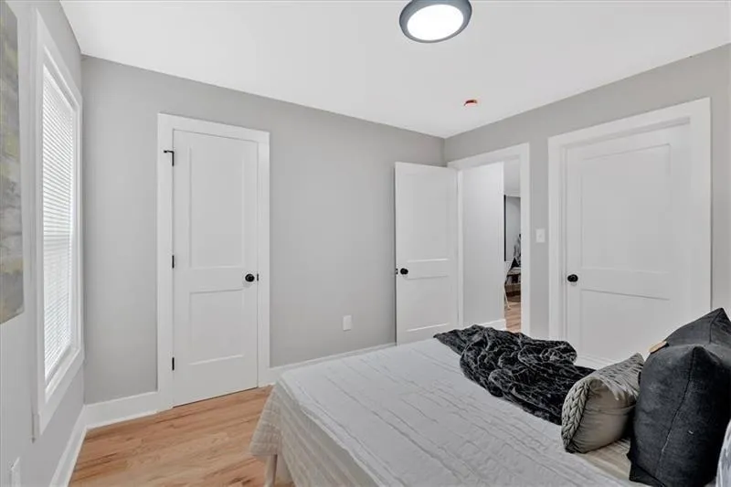 Bedroom featuring light wood-type flooring and baseboards
