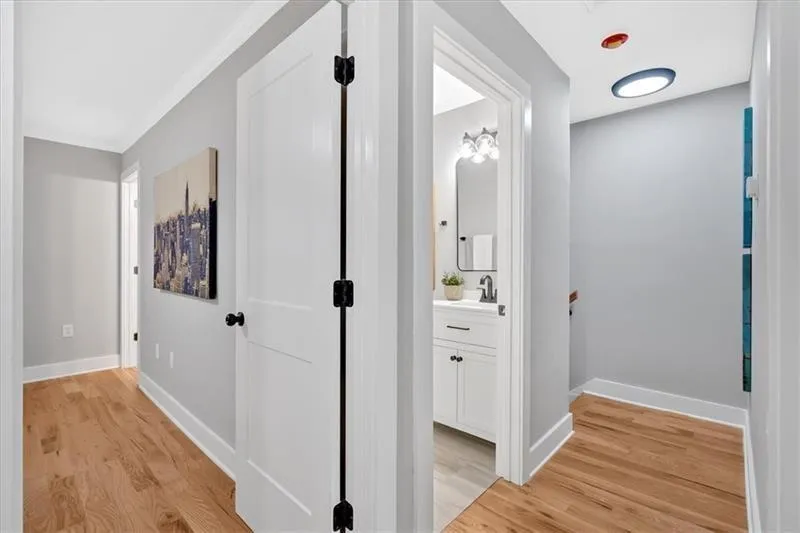Hallway featuring light wood-style floors and baseboards