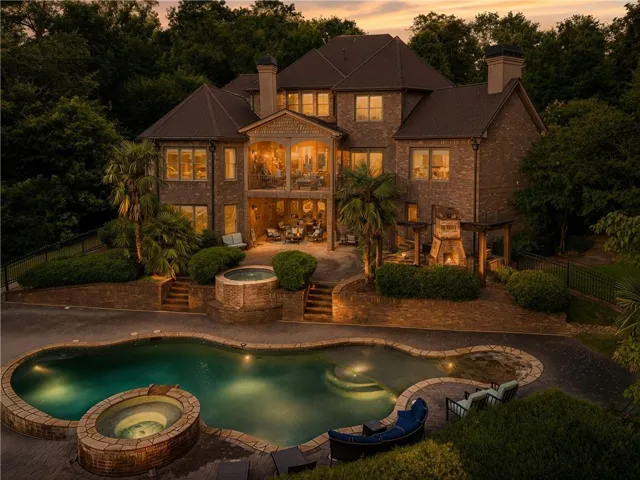 Brick exterior residence featuring multiple levels of outdoor living
