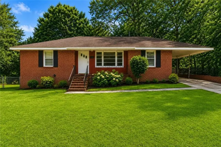 Brick exterior with a covered carport