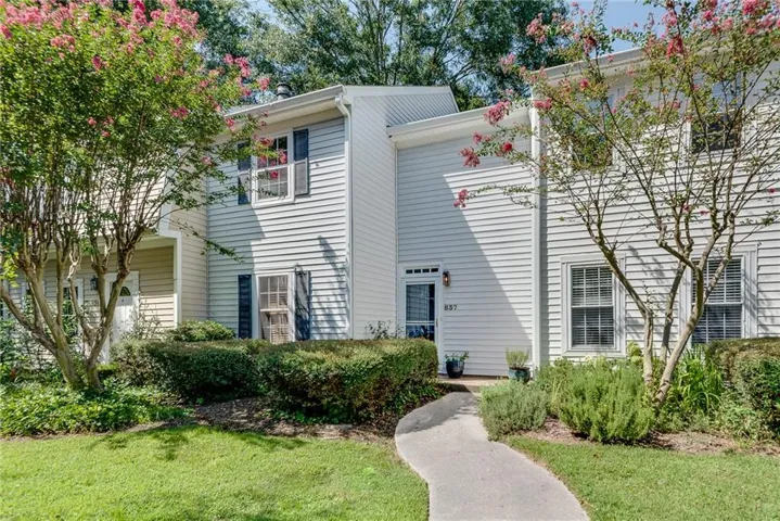 Two-story exterior with vinyl siding and black shutters