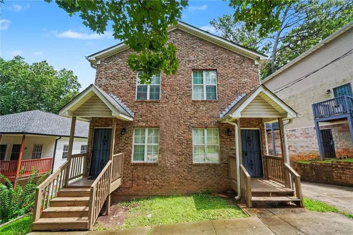 Brick facade building with two independent entrances, each featuring a covered porch