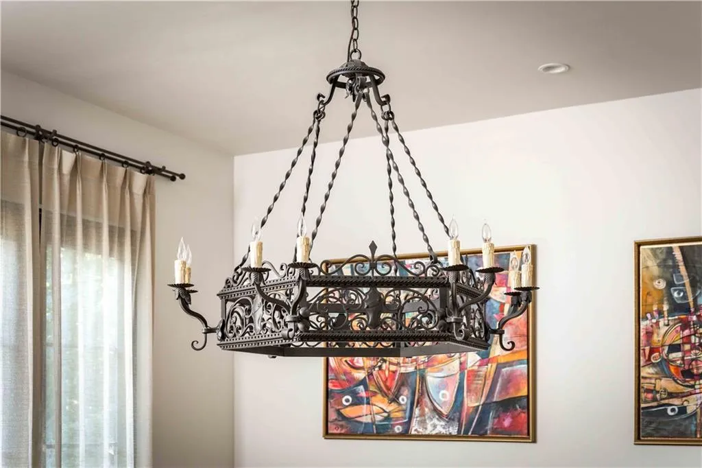 Ornate wrought iron chandelier with candle-style lights