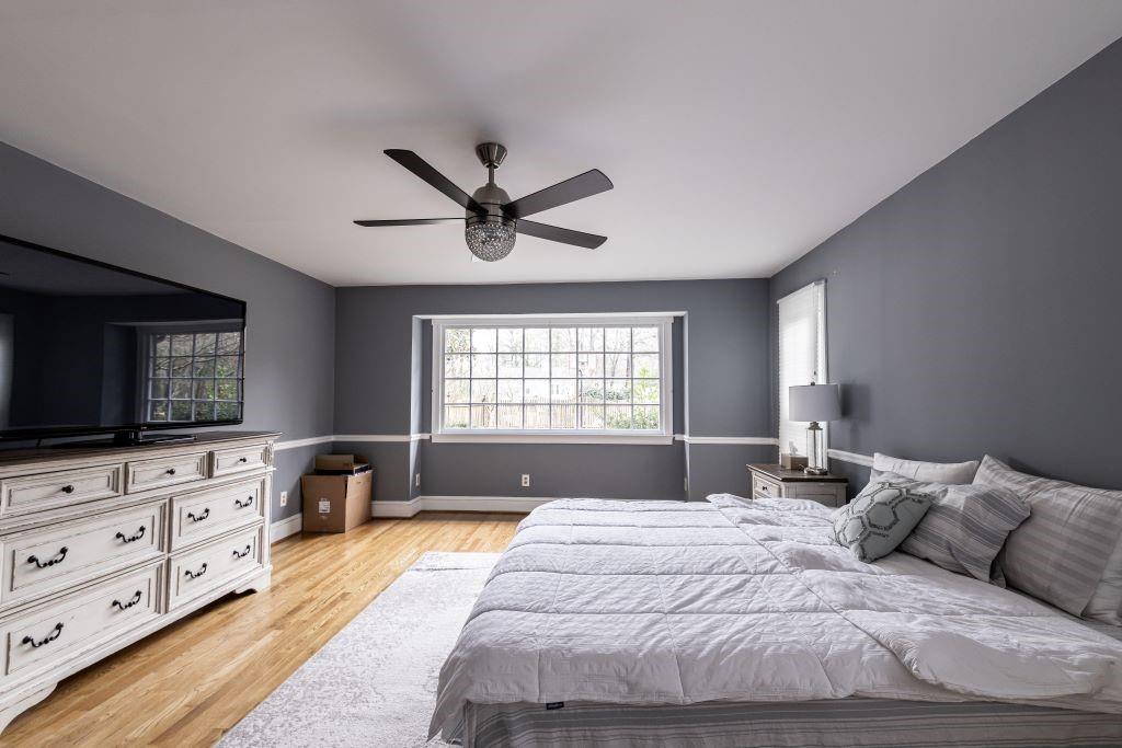 Bedroom featuring light hardwood / wood-style flooring and ceiling fan