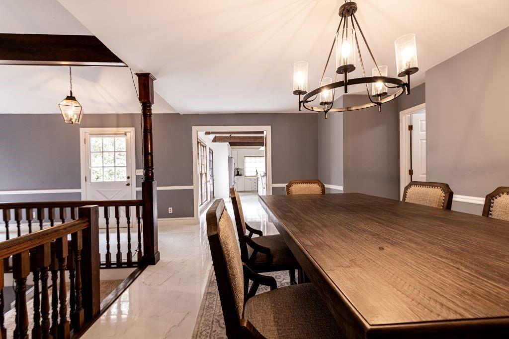 Dining space with an inviting chandelier and light tile floors