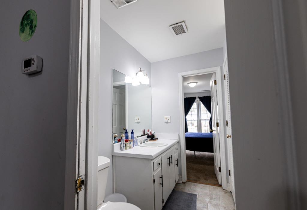 Bathroom featuring toilet, tile flooring, and large vanity