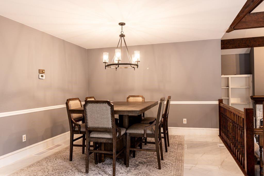 Tiled dining room with a notable chandelier
