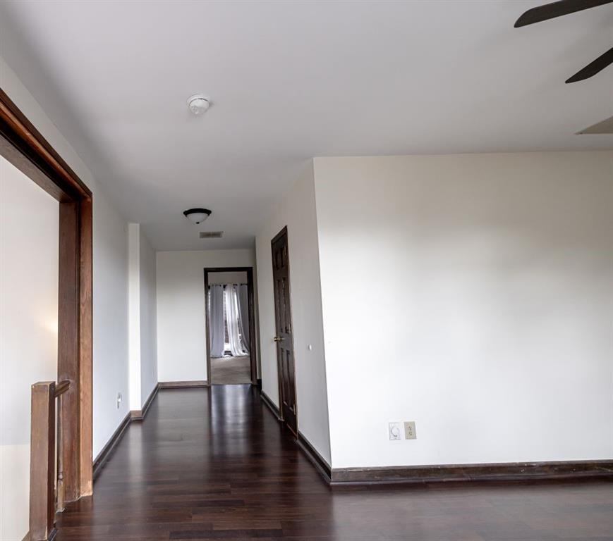 Corridor featuring dark hardwood / wood-style flooring