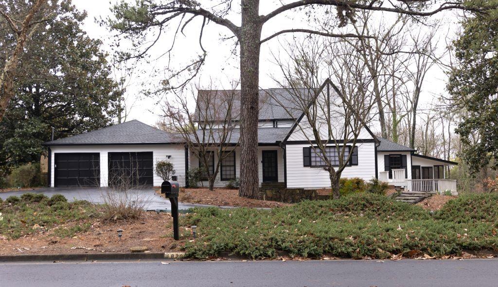 View of front facade featuring a porch and a garage