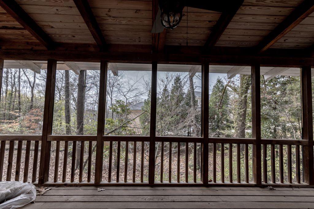 Unfurnished sunroom with wood ceiling and beamed ceiling