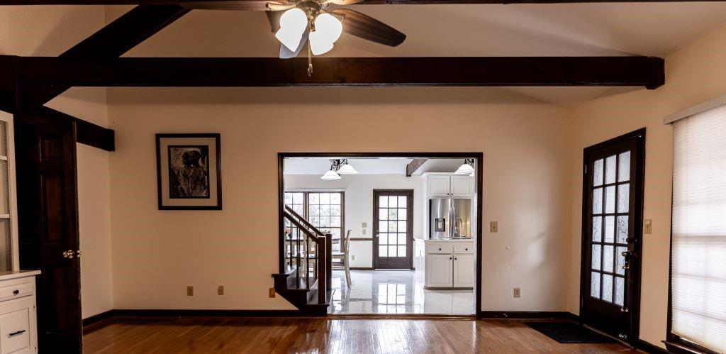 Foyer entrance featuring hardwood / wood-style flooring, french doors, ceiling fan, and beam ceiling