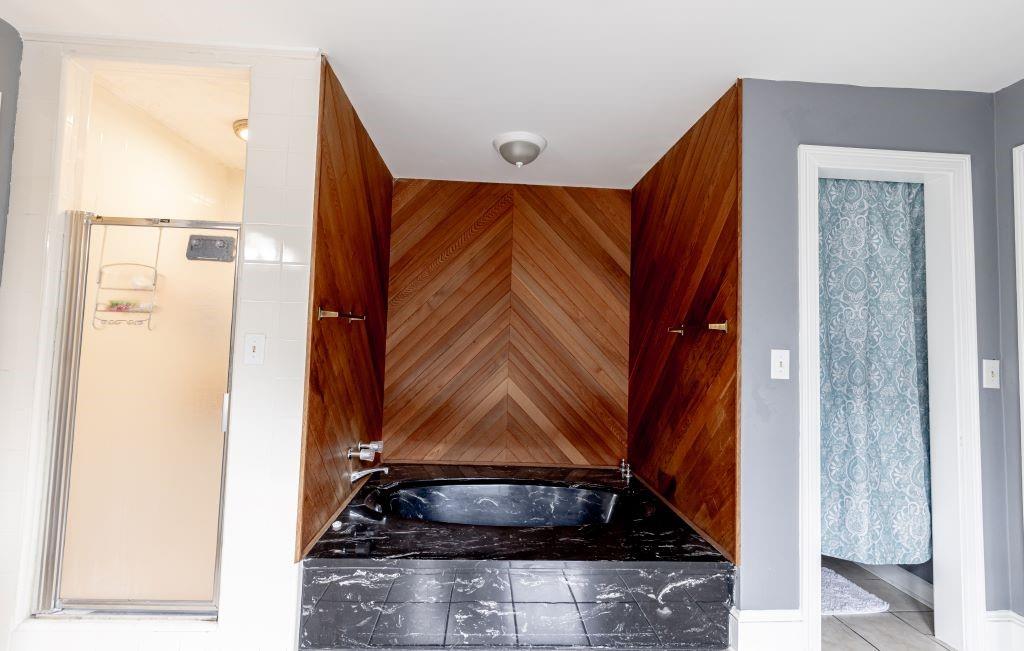 Bathroom with tile flooring and separate shower and tub