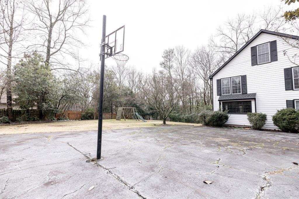 View of sport court featuring a playground