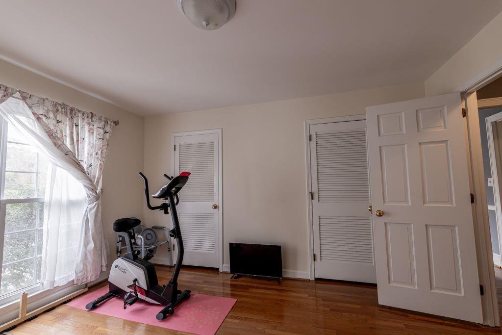 Workout area featuring dark hardwood / wood-style flooring