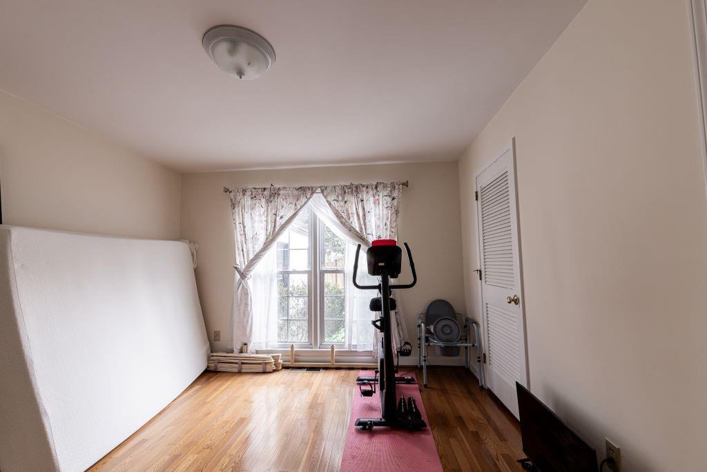 Exercise area featuring wood-type flooring