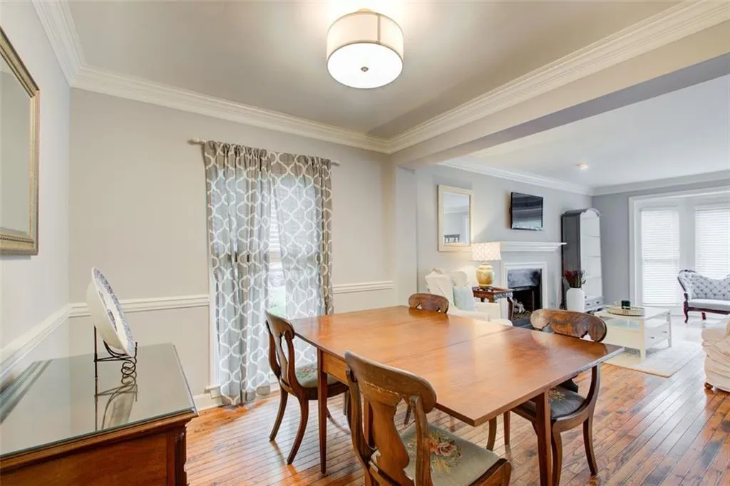 Dining room featuring wood-type flooring and crown molding