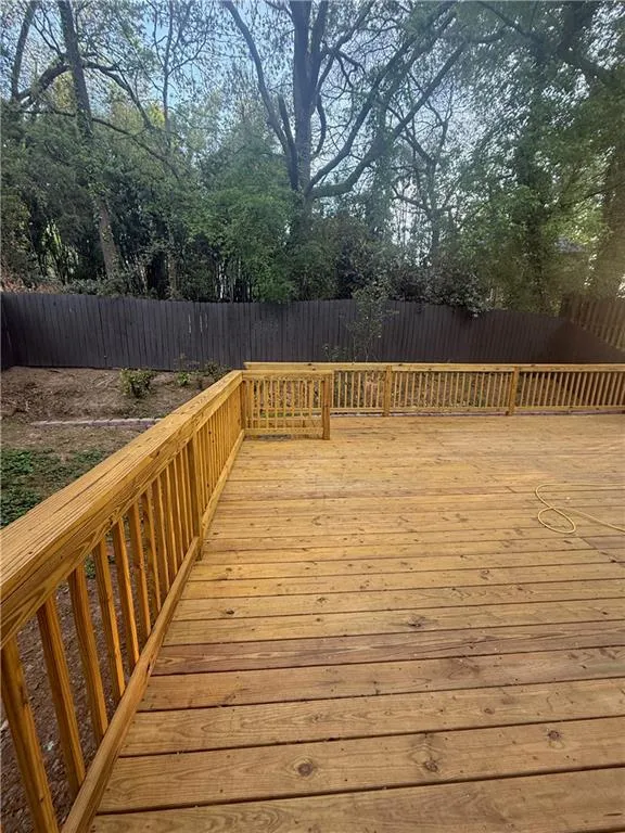 Wooden terrace featuring a fenced backyard