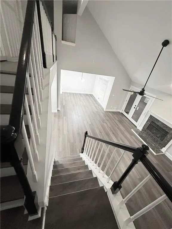 Stairs featuring wood finished floors and ceiling fan