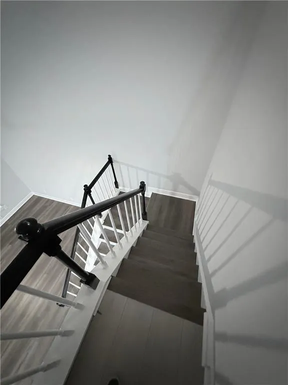 Staircase featuring wood finished floors