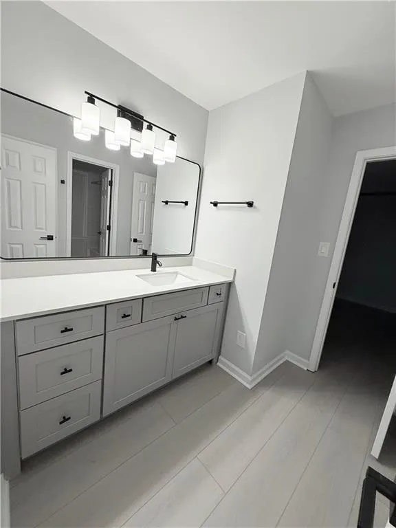 Full bathroom featuring vanity and light wood-style flooring