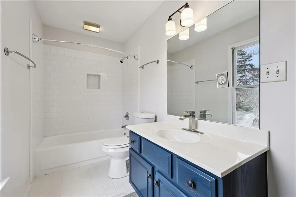 Full bathroom featuring vanity and washtub / shower combination