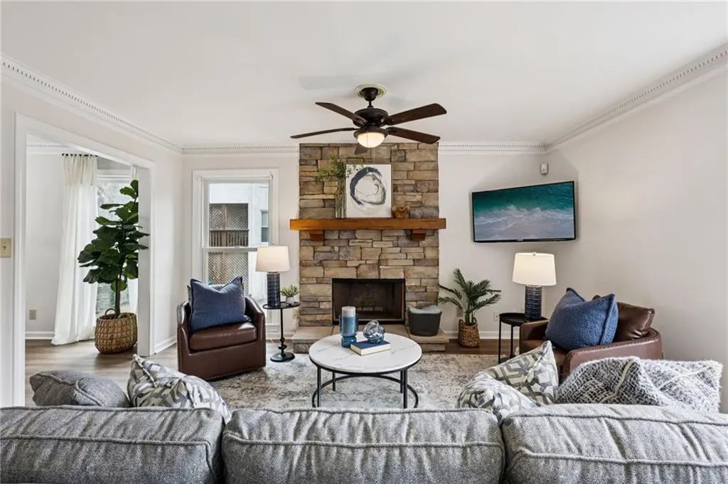 Living room featuring stone fireplace and a brand new tv!
