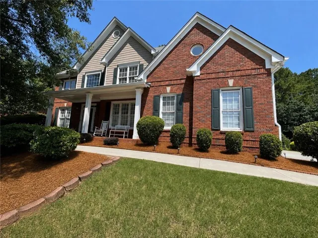 Brick exterior with gabled roof lines and round window accent