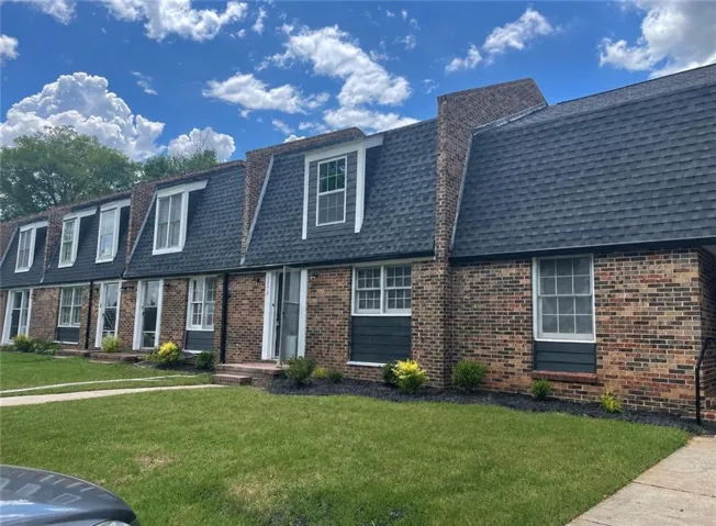 Brick exterior with dark gray siding accents