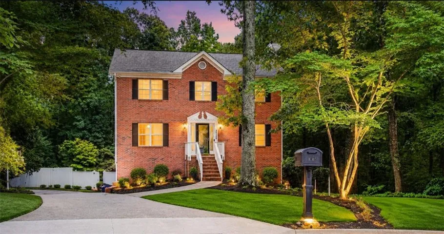 Brick facade residence with a gabled roofline and black shutters