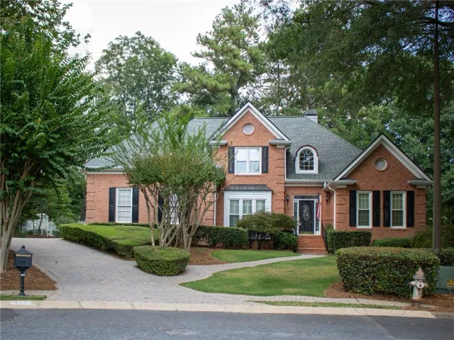 Brick exterior with a gabled roof and arched window