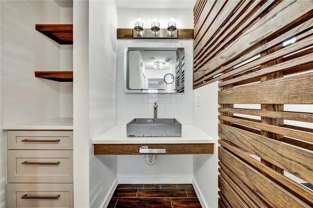 Bathroom with vanity, wood tiled floors, and backsplash