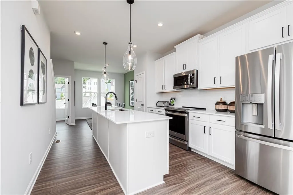 Gorgeous designer kitchen with spacious island, cabinet space & SS appliances!