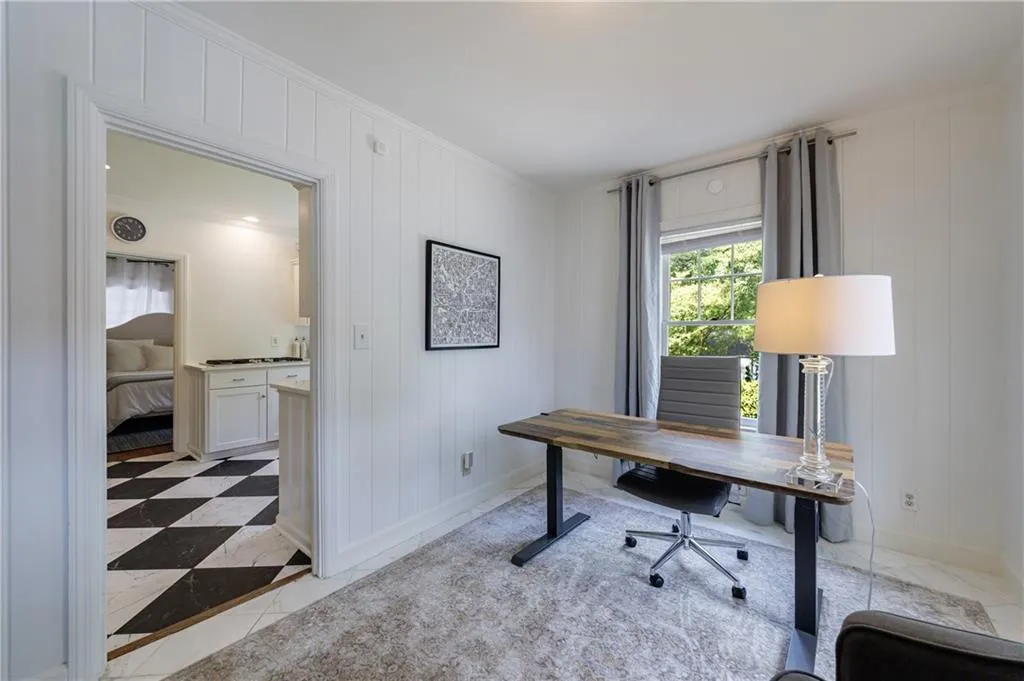 Office with baseboards and crown molding