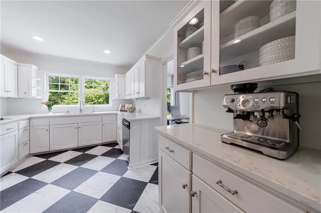 Kitchen with a sink, white cabinetry, open shelves, glass insert cabinets, and recessed lighting