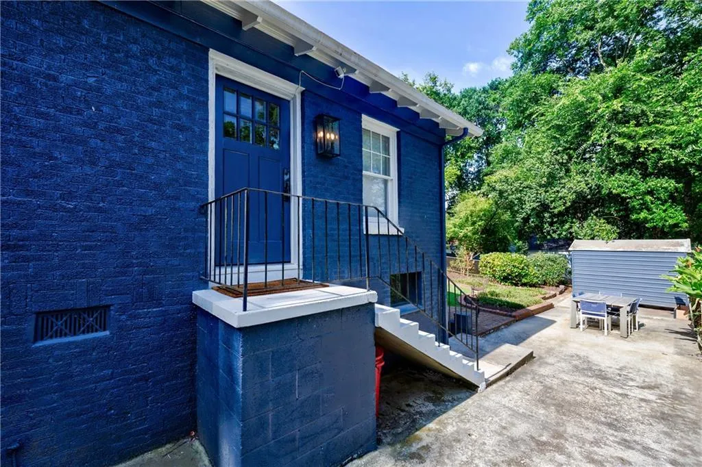 Entrance to property with outdoor dining space and a patio area