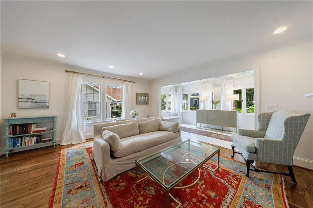 Living area featuring healthy amount of natural light, wood finished floors, recessed lighting, baseboards, and ornamental molding