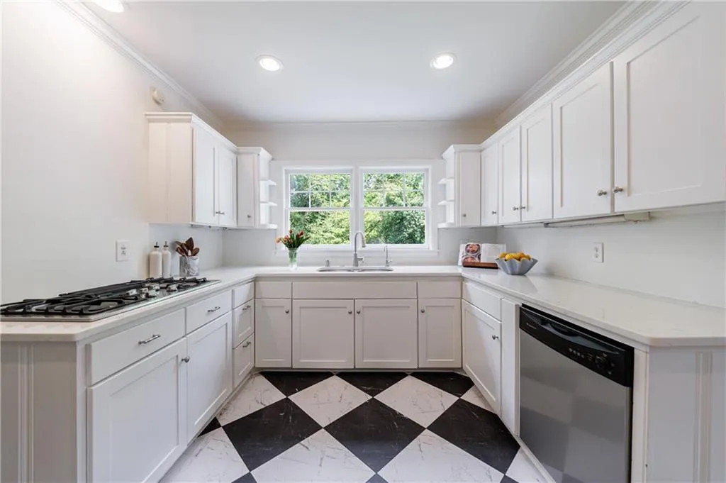 Kitchen with stainless steel appliances, a sink, open shelves, crown molding, and white cabinets