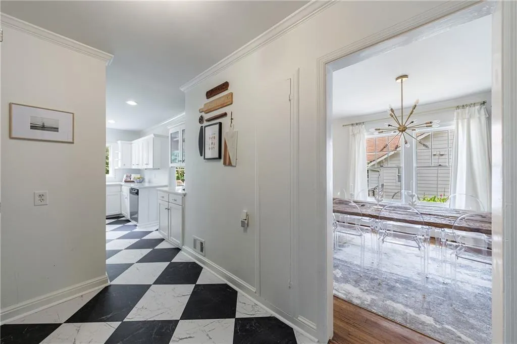 Hall with baseboards, crown molding, a chandelier, and recessed lighting