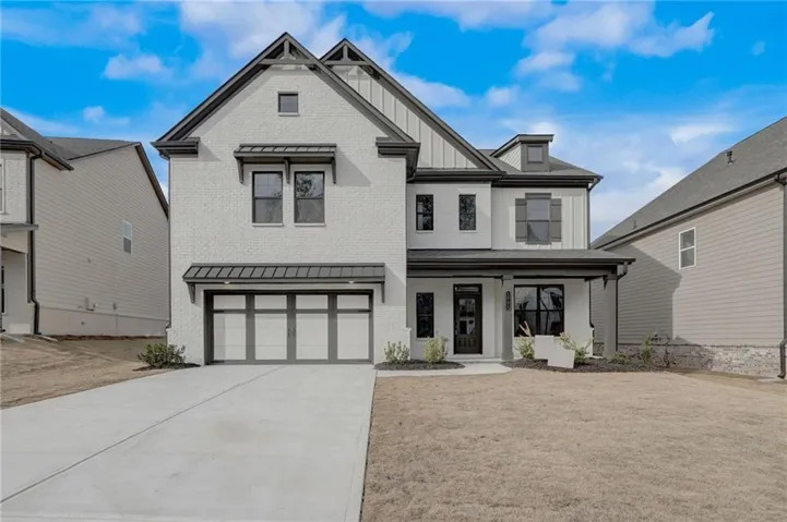 Contemporary two-story exterior with white brick and dark trim accents