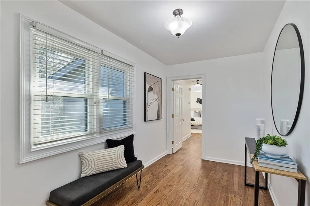 Sitting room featuring baseboards and wood finished floors