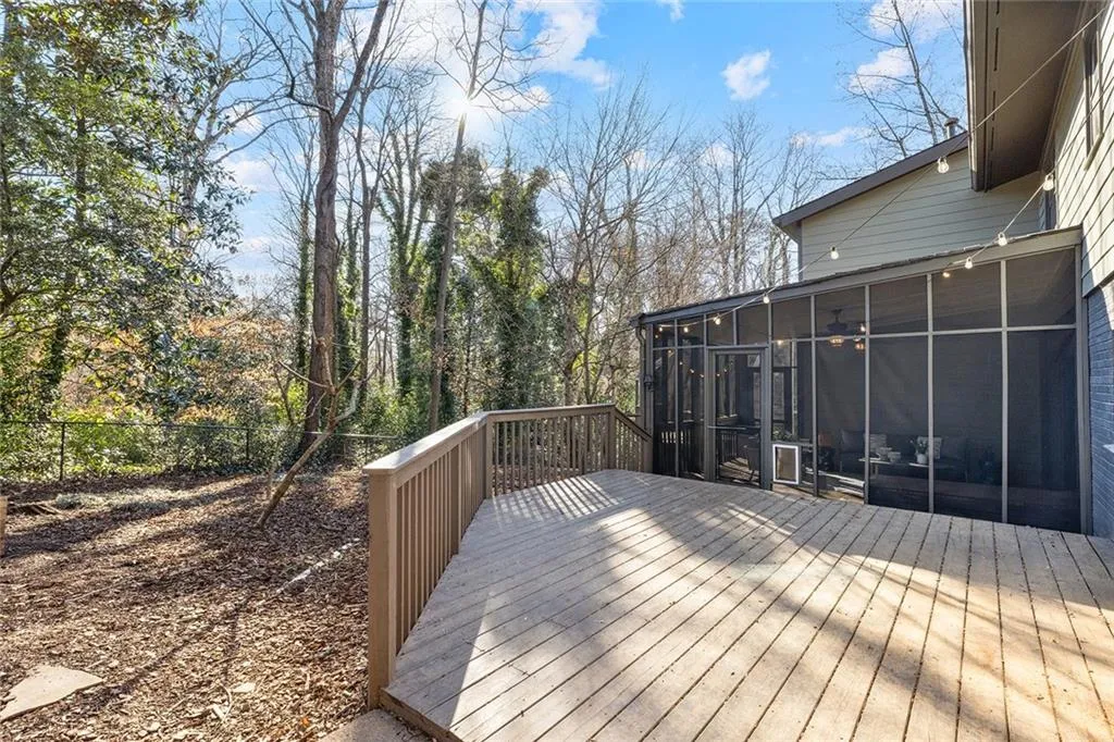 Wooden deck featuring a sunroom