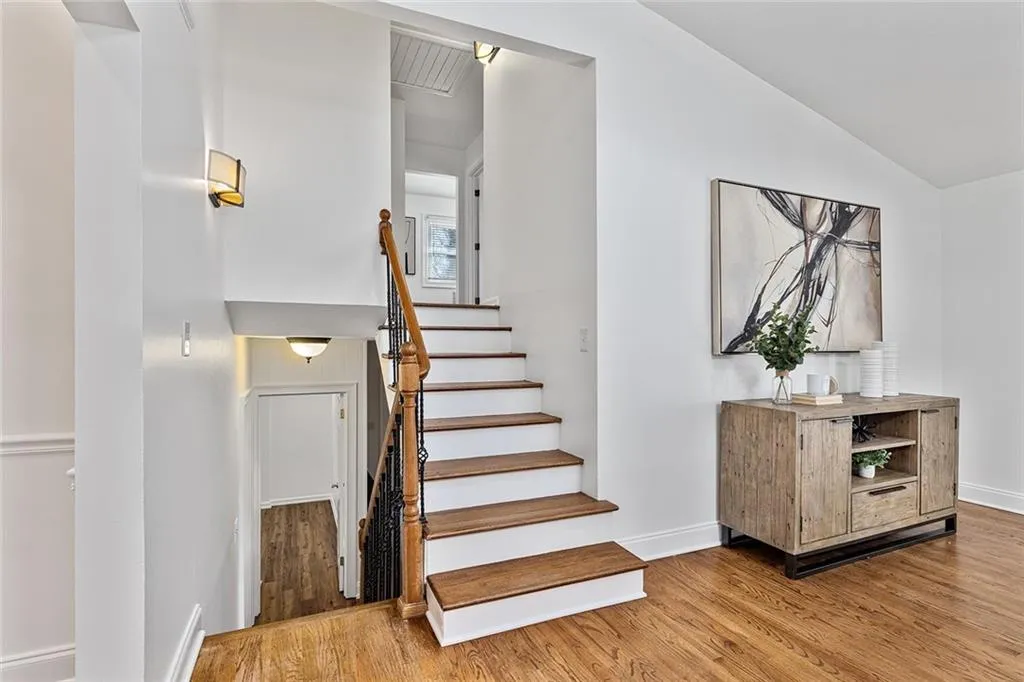 Stairway featuring baseboards and wood finished floors