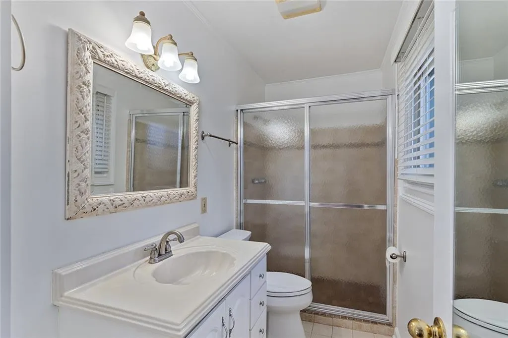 Full bathroom featuring vanity, a shower stall, and light tile patterned floors