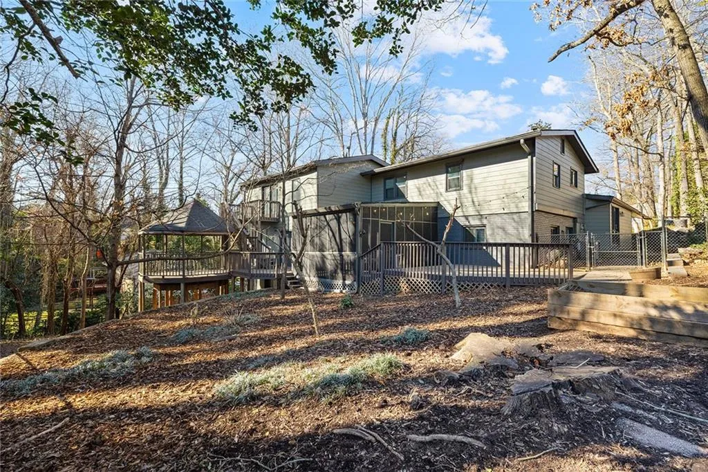 Rear view of property featuring a wooden deck