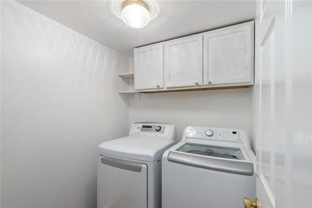Laundry area with washing machine and clothes dryer and cabinet space