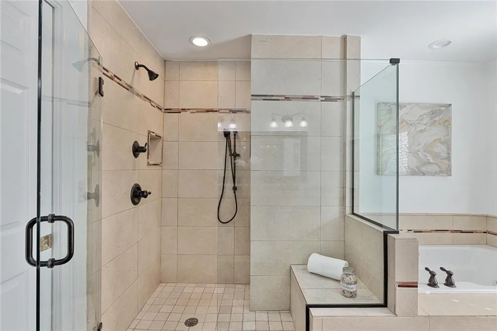 Full bathroom featuring a stall shower and a garden tub