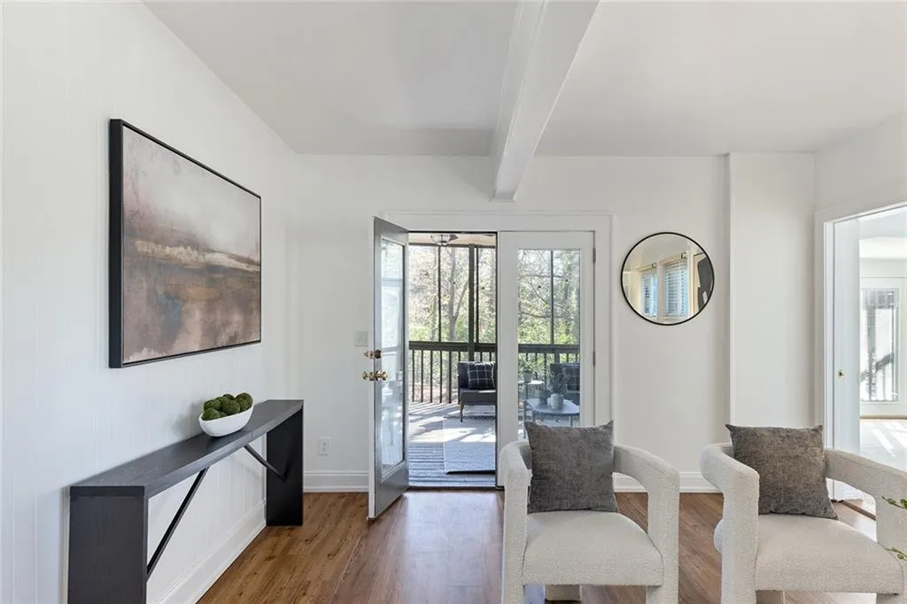 Living area featuring beamed ceiling and wood finished floors