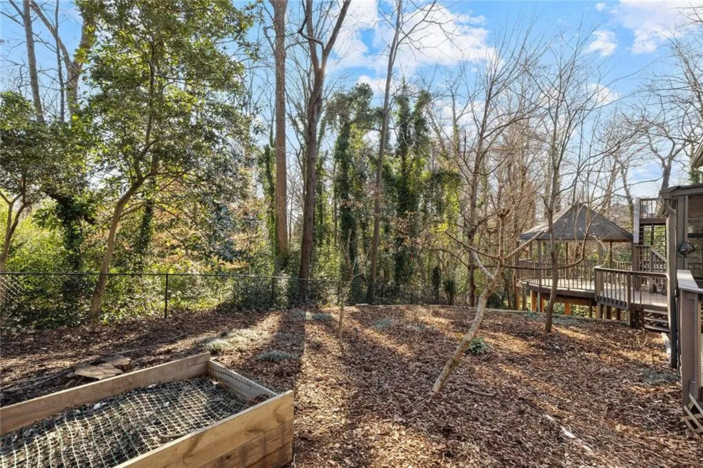 View of yard featuring a gazebo, a wooden deck, and a garden